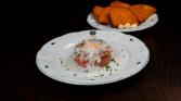 Beef tenderloin tartare with cow's cheese and toast with garlic and pickled onions